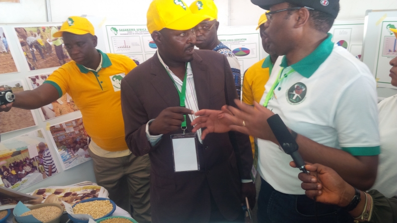 Hon. Minister of Agriculture at SAA’s stand discussing with the Country Director Dr. Sani Miko