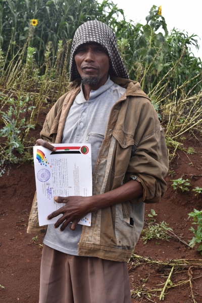 Exemplary Farmer Bashir Lema with certificate of recognition awarded to him by the administration