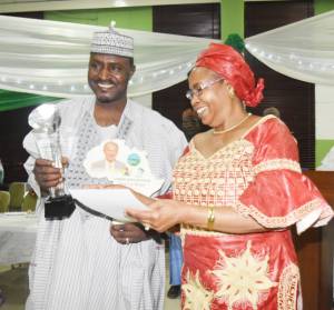 SAA Managing Director Dr. Juliana Rwelamira receiving the award on behalf of the Nippon Foundation Chairman, Mr. Yohei Sasakawa from the hands of SG-2000 Nigeria Country Director Prof. Sani Miko