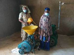 Assa Sanogo (right) and an SAA field technician standing in the groundnut pulp mill unit
