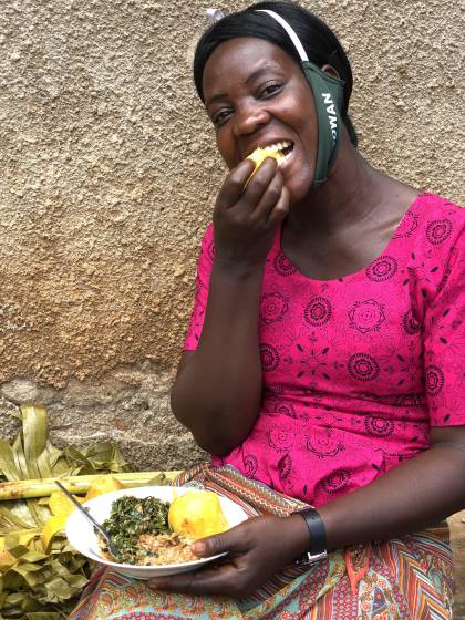 A lady enjoying vitamin A sweet potato and vegetables in Bugiri District, Uganda
