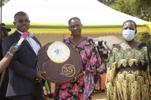 State Minister for Agriculture, Animal Industry and Fisheries, Hon. Fred Kyakulaga Bwino awards best farmers groups  at SAA 35th anivesary celebrations -Kibuku district.
