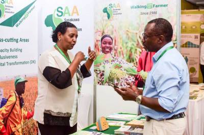 SAA staff explaining our work to a booth visitor