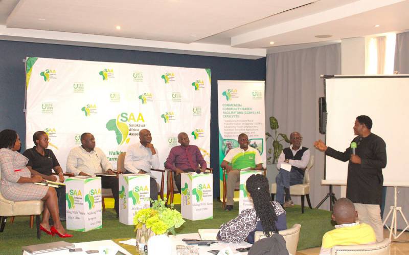 Mr. Anyang Robert, Country Director, moderating a panel discussion on “Ecosystem Players Facilitating Access to Innovations.” From left to right: Alanga Faith (Vision Fund – Agricultural Finance), Monalisa Mutesi (Virtual Agronomist/ISSDA – ICT Service Provider), Douglas Opio (China North – Agro-Machinery), Godfrey Katwere (NASECO – Input Provider), Fred Migade (Centenary Bank – Finance), David Katwere (Wash and Wills – Agricultural Mechanisation), and a representative from Kironde Agro – Off-taker.