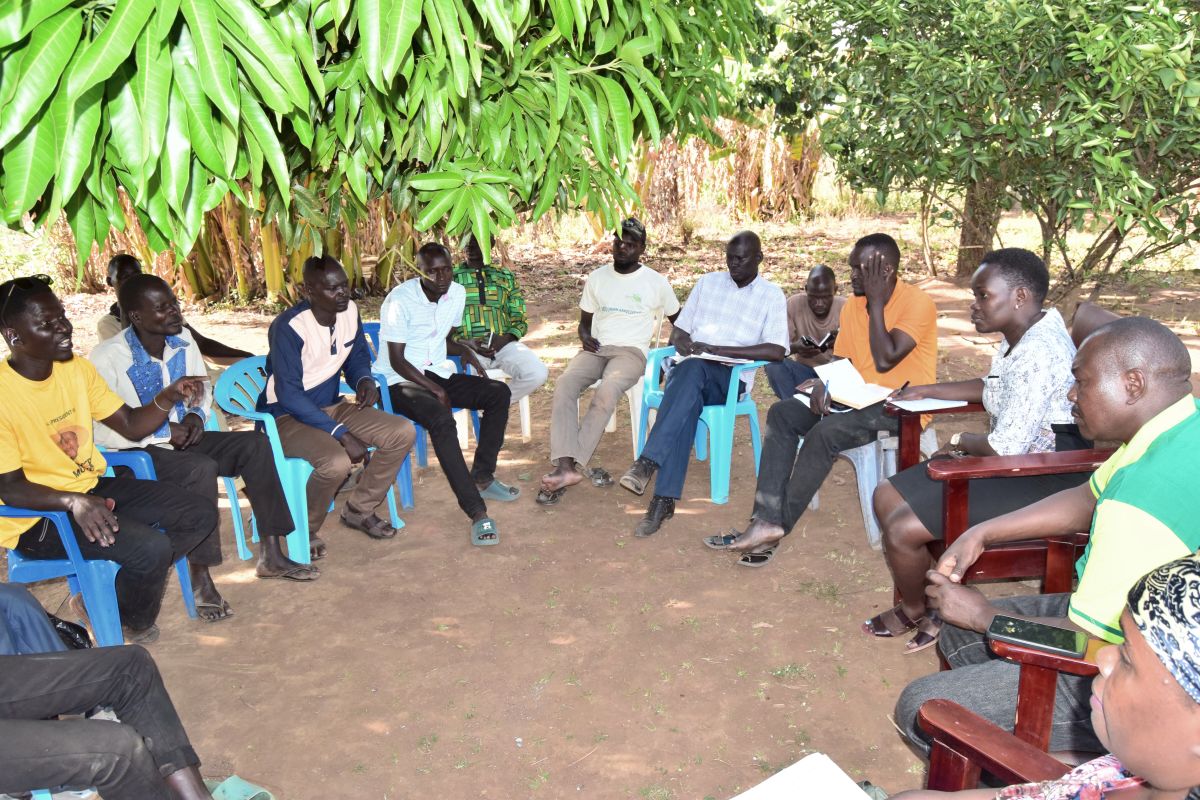 Farmers, SAA, and Stanbic bank teams discussing financial opportunities to improve production and markets.