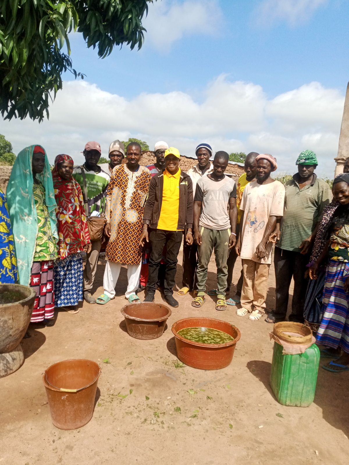 Group photo of farmers and CAT members in Koloniboundio after a practical training session on biopesticide preparation.
